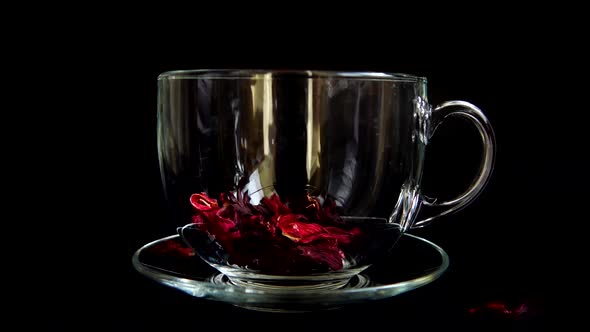 Preparation of Hibiscus tea in a glass cup. alt