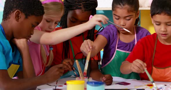 Preschool Class Painting at Table in Classroom alt