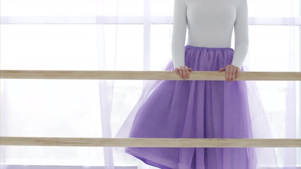 Professional Ballerina Is Puts Her Leg on the Barre Stand