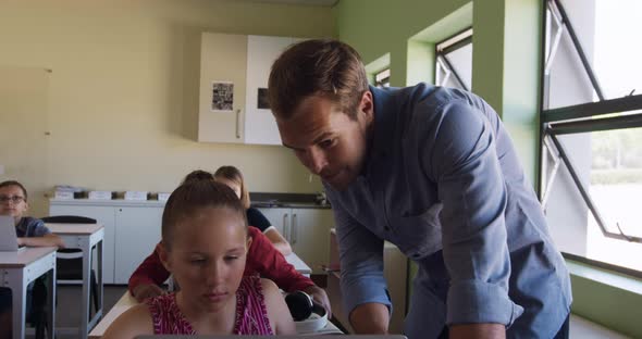 Male teacher teaching in the class alt