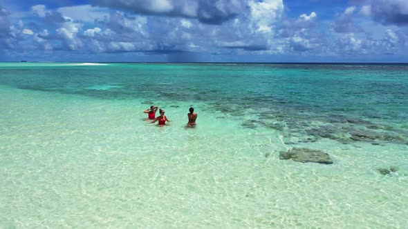 Beautiful ladies relaxing on perfect seashore beach break by aqua blue sea and white sand background alt