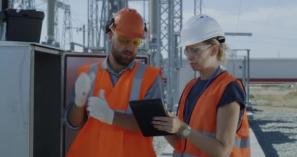 Engineers Checking Transformer Box on Power Plant alt