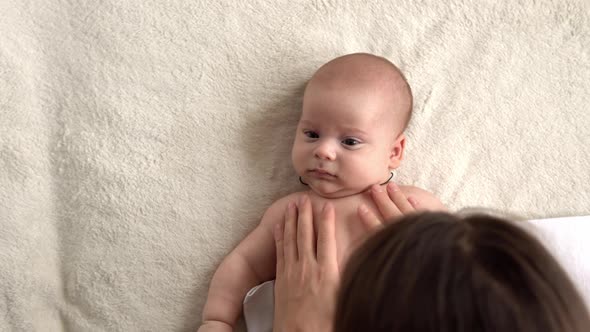 Authentic Close Up Shot Young Neo Mother Mum is Playing with Nake Newborn Child Baby on White Soft alt