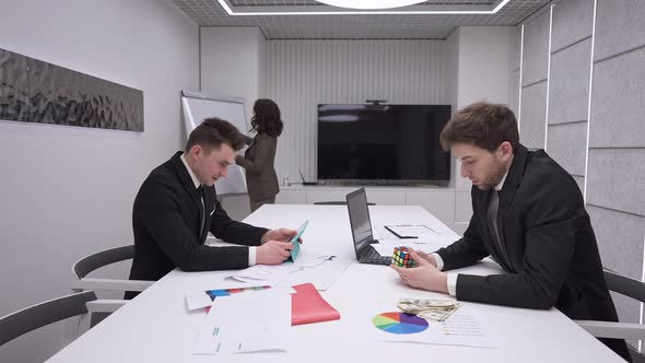 Irresponsible Caucasian Men Gaming Online and Playing Rubik's Cube Ignoring Woman Talking Presenting alt