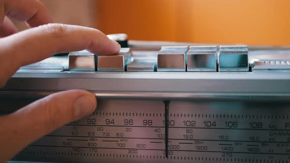 Finger Presses Stop Button on an Old Retro Vintage Tape Recorder or Radio alt