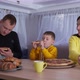 Picnic Trip Parents Eat Fast Food with Little Boys During Joint Trailer Journey on Family Weekend