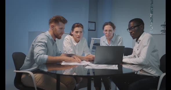 Group of Young Modern People in Smart Casual Wear Discussing Business Sitting in Creative Office alt