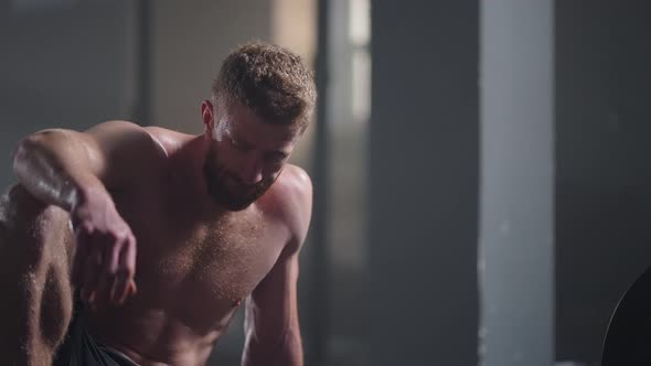 Exhausted Young Men Resting After Intensive Workout in Gym alt