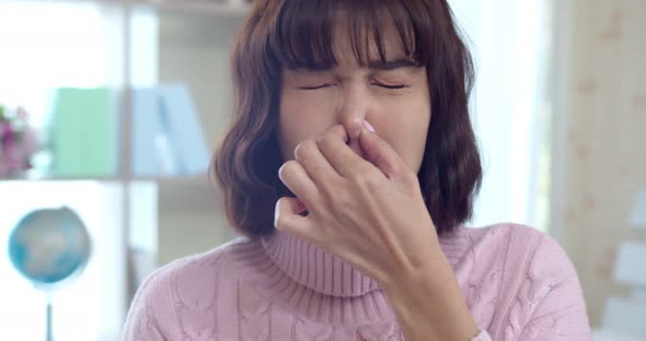 Young woman closed her nose and mouth when feels stink