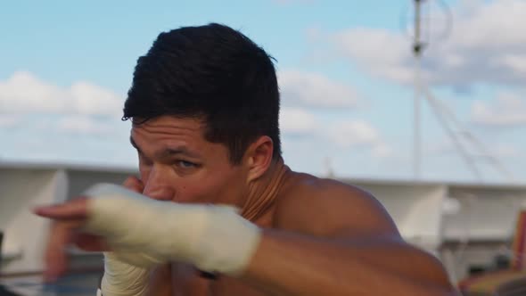 Attractive Strong Young Man Does Box Workout Exercising Shadow Boxing Outdoors Onboard Cruise Ship
