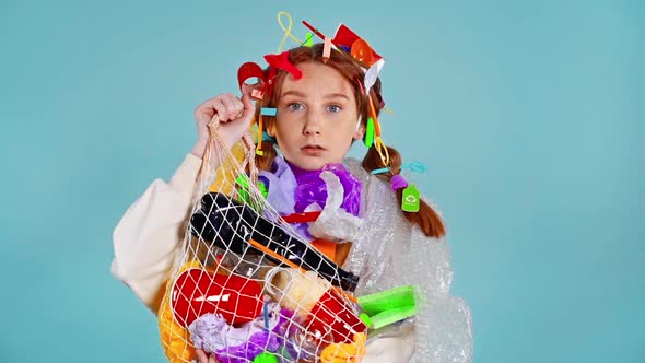 Girl holding package with garbage.