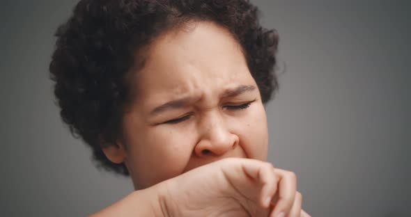 Young African Woman Yawning Tired Covering Mouth with Hand Isolated on Gray Background alt