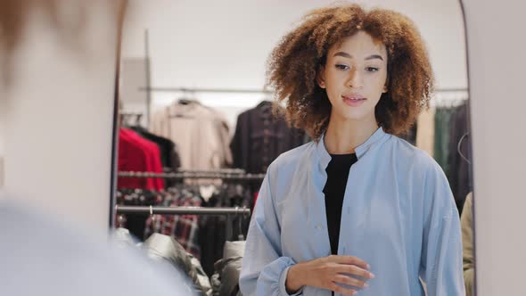 African American Woman Shopper Girl Female Consumer in Mall Store Trying on Blue Stylish Silk Linen alt