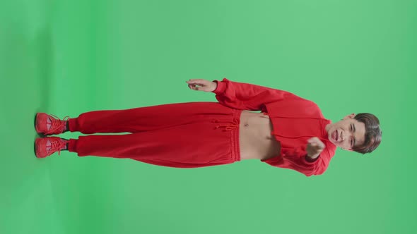 Full Body Of Angry Asian Transgender Male Scolding While Standing On Green Screen In The Studio alt