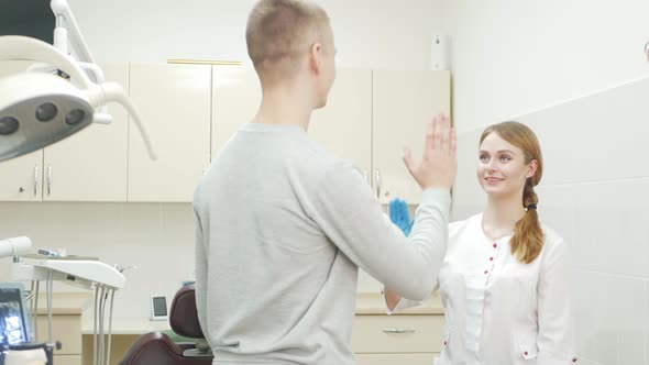 Beautiful Female Dentist in Office in Clinic Satisfied Happy Client Shakes Hands Excellent