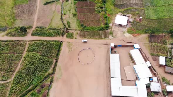 People Standing in Circle in School Playground in Malawi, Africa, Drone View alt