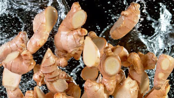 Super Slow Motion Shot of Flying Ginger Cuts and Water Side Splash at 1000 Fps alt