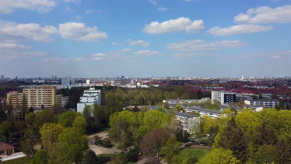 Large apartment buildings and small single-family homes Dramatic aerial view flight fly backwards dr alt