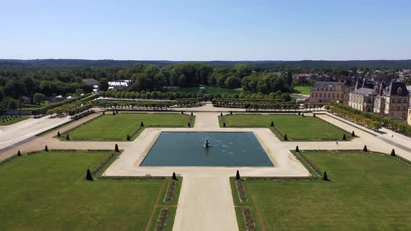Aerial View of Medieval Landmark Royal Hunting Castle Fontainbleau and Lake with White Swans, France alt