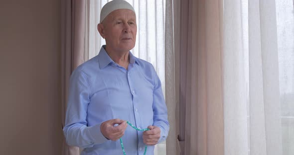 An Old Man with Rosary Beads Praying