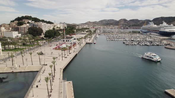 Aerial forward ascending over promenade at Cartagena touristic port, Spain