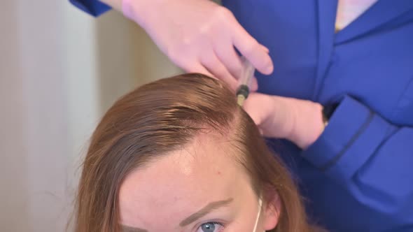 A Beautician Makes Injection of Vitamins and Minerals in the Woman's Scalp To Prevent Hair Loss alt