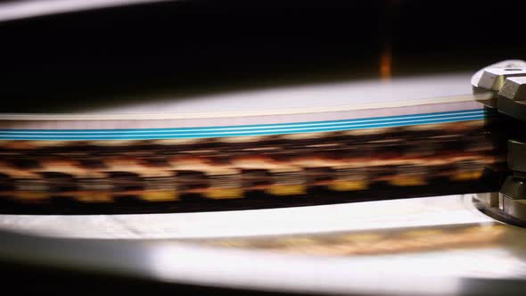 Close Up of a Moving 35Mm Film Stripe in a Movie Theater alt