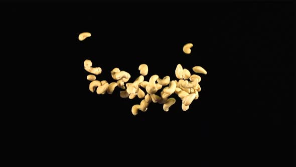 A heap of cashew up and down on a dark background