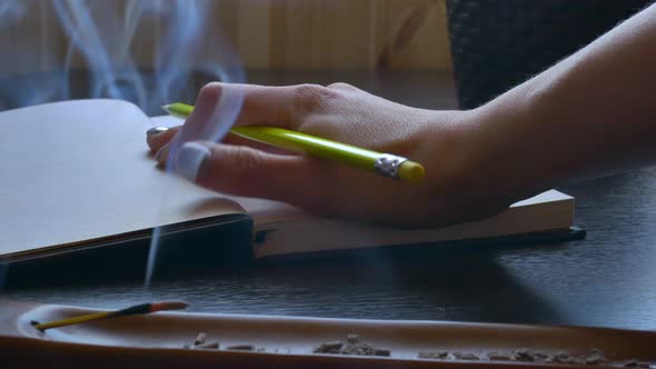 the Girl Writer Begins to Write a Book and Writes a Pencil in a Notebook There is an Incense Stick alt