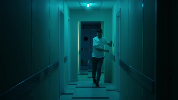 Man with a Lack of Coordination of Movement Walks Along Corridors of Hospital