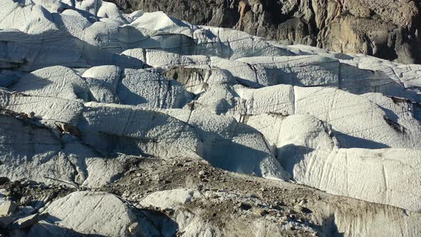aerial drone flying parallel to the white passu glaciers in Hunza Pakistan during a sunny summer day alt