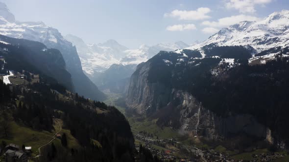 Aerial is flying high up from Wengen and shows Lauterbrunnen Town from a distance, Switzerland alt