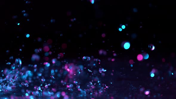 Super Slow Motion Abstract Shot of Splashing Neon Water at 1000Fps. alt