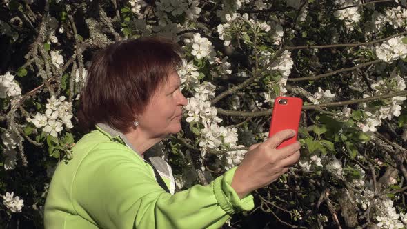 Closeup Shot of a Lady Taking Selfies in an Apple Orchard