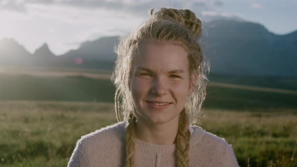 Portrait of happy smiling young woman with dreadlocks looking at camera alt