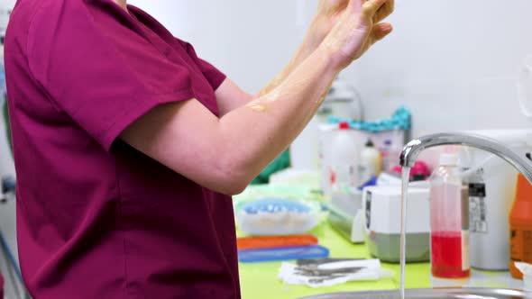 Surgeon Washing Her Hands Before Beginning the Surgery alt