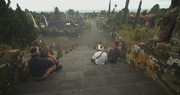 Tilting Reveal Shot From the Top of the Besakih Temple in Bali View of the Tourists Exploring the alt