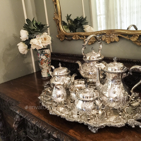 Antique silver tea set and tray on vintage table Stock Photo by