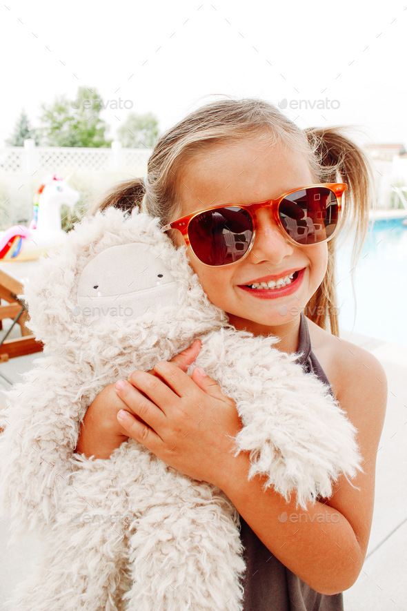 Little girl hugging a stuffed animal