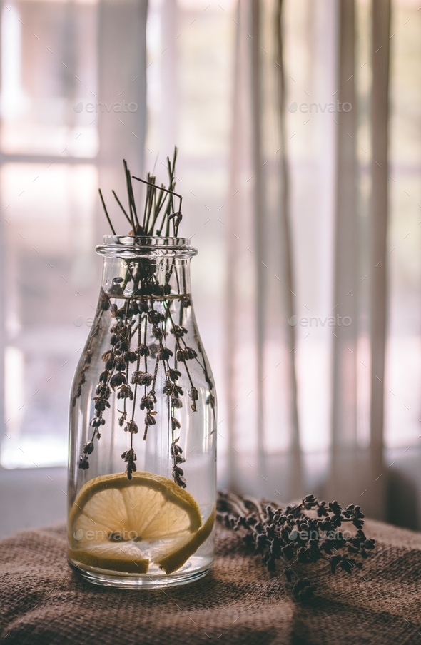 Lavender water with lemon in a glass bottle