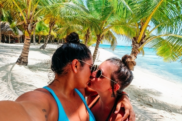 Lesbian Couple In Love Young Women Kissing On A Tropical Beach In Dominican Republic Stock