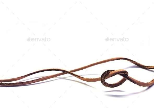Less is more, minimalism. A loose knot on a leather string in an airy composition. Solution