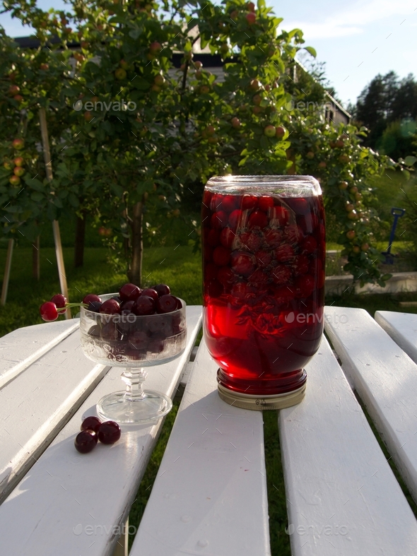 cherry compote drink on garden background Stock Photo by bodan22