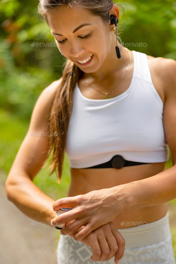Portrait of woman using fitness smart watch device under workout - Stock Photo - Images