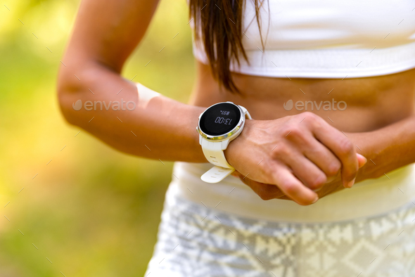 Close-up of woman using fitness smart watch device under workout - Stock Photo - Images