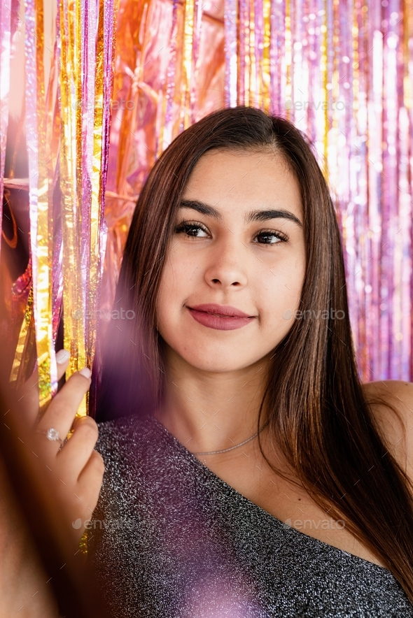 Closeup of woman in glitter dress standing on glitter purple and gold