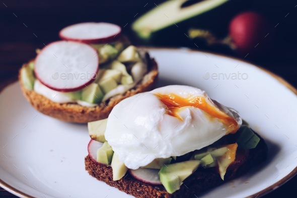 The sandwich with a garden radish, avocado and egg plows