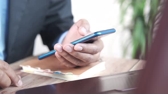 Close Up of Young Man Hand Using Smart Phone alt