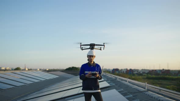 Engineer use drone for inspection installation solar cell panel on rooftop of factory