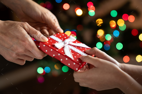 Christmas gift giving between parent and child - Stock Photo - Images